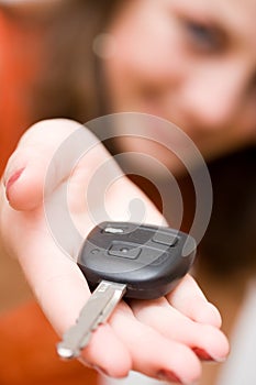 Sales woman offering car keys