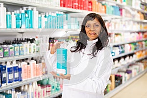 Salesgirl helping to choose hair products in store