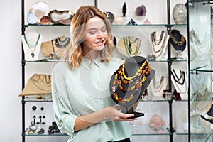 Salesgirl offering amber necklaces