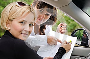 Saleslady assisting a customer to buy a car
