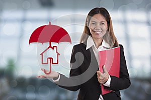 Salesman agent hand holding umbrella protection home.