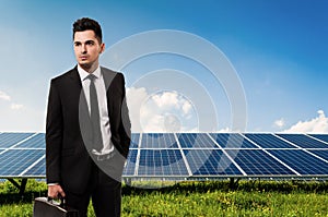 Salesman or businessman holding briefcase on solar power panels