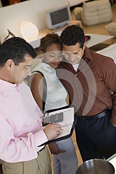 Salesman Calculating Purchase Amount Of Couple In Store