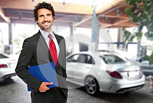 Salesman in a car showroom