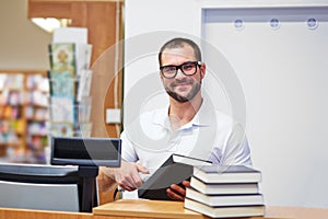 Salesman at the checkout in a bookstore