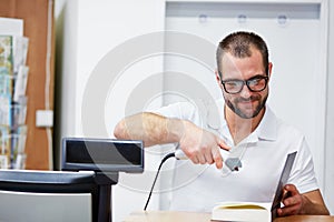 Salesman at the checkout in a bookstore