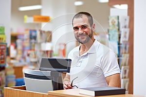 Salesman at the checkout in a bookstore