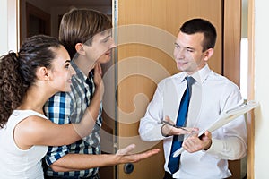 Salesman forcing family couple photo