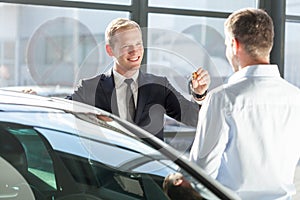 Salesman giving car key