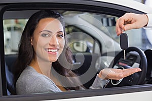 Salesman giving keys to a smiling woman