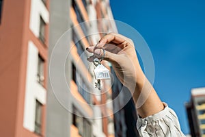 Salesman handing keys in the residential area background