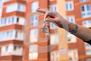 salesman handing keys in the residential area background