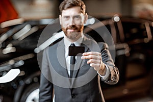 Salesman with key at the car dealership