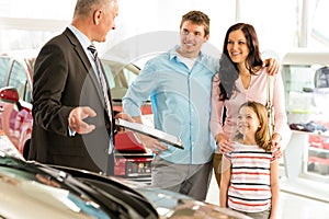 Salesman offering a car to family