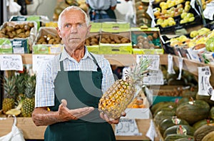 Salesman offering fresh fruits and vegetables