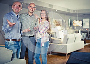 Salesman offering furniture to family couple