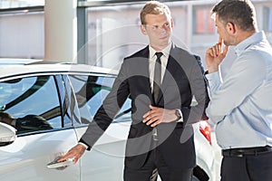 Salesman presenting auto to customer