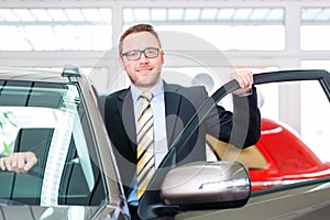 Salesman selling car at dealership