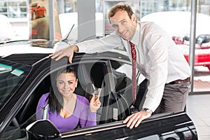 Salesman selling a car to happy customer