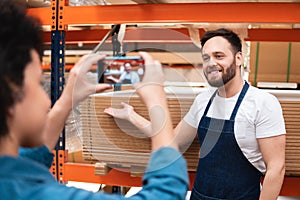 Salesman showing stock of product in store at warehouse