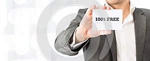 Salesman showing a white business card with 100% free sign photo