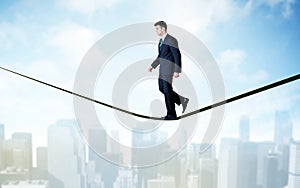 Salesman walking on rope above the city