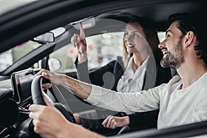 Salesperson with customer in car dealership