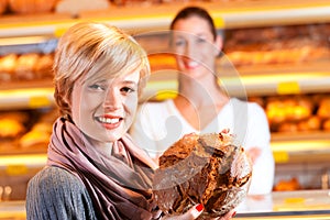 Salesperson with female customer in bakery