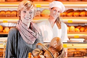 Salesperson with female customer in bakery