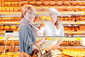 Salesperson with female customer in bakery