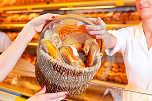 Salesperson with female customer in bakery