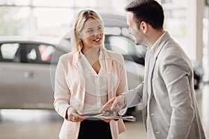 Salesperson workin at car dealership