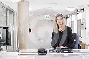 Saleswoman behind a ticket counter