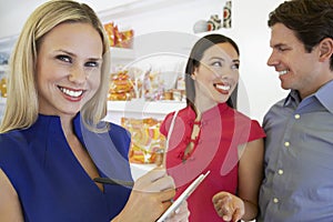 Saleswoman And Couple At Store photo