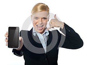 Saleswoman displaying new iphone to camera photo