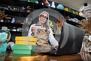 Saleswoman register discount card on laptop at store