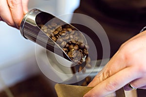 Saleswoman selling bulk coffee at an organic store.