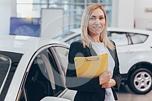Saleswoman working at car dealership