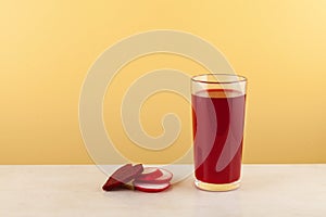 Salgam or fermented beet juice in tall grass. Turkish drink, made from fermented purple carrots, turnips or beets. Yellow
