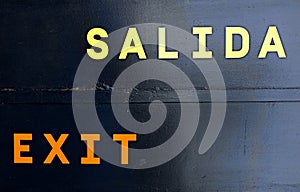 salida exit spanish and english words on black background