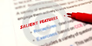 salient features word written on english language with red colour on white paper photo