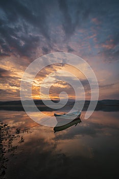 Salihli turkey solo boat with refletion sunset photo