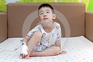 Saline Solution On Hand of Patients Child sit on bed feel boring healthy nursing care of hospital life insurance