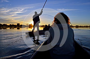 Saling in the Okavango delta at sunset, Botswana