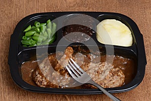 Salisbury steak tv dinner with a fork