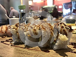 Salmon, avocado and cucumber sushi roll with teriyaki sauce