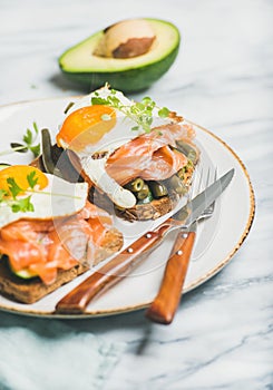 Salmon, avocado, fried egg, sauted green beans and sprouts sandwiches