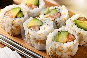 Salmon and avocado pear uramaki sushi rolls photo