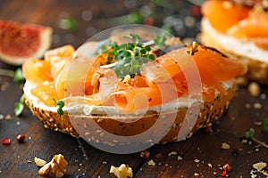 Salmon Bagel Sandwich with figs, cress salad, walnuts, cream cheese and grain on rustic wooden background. healthy