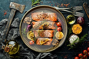 Salmon baked in a metal tray with vegetables and rosemary. Recipe. Seafood.